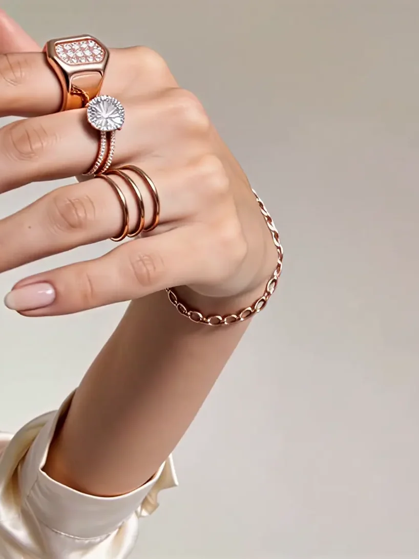 Close crop on the hand and the four rings.